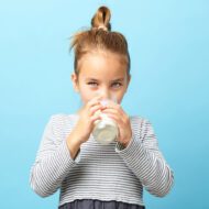 Girl drinking beverage supplemented with calcium